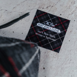 A label displaying The Real Mary King's Close brand logo and a message reading "100% Pure Wool Woven in Scotland"
