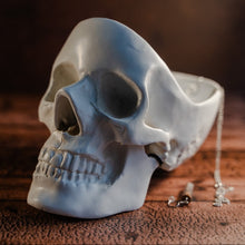 Load image into Gallery viewer, White skull tidy displayed on a wooden table with jewellery hanging out of it