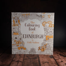 Load image into Gallery viewer, The Colouring Book of Edinburgh front cover displayed on a wooden slatted background