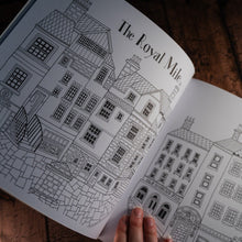 Load image into Gallery viewer, Line drawing of the Royal Mile for colouring in as displayed in an open book