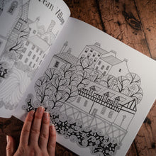 Load image into Gallery viewer, Line drawing of Edinburgh's Dean Village for colouring in as displayed in an open book