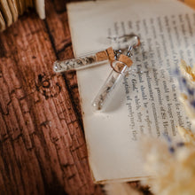 Load image into Gallery viewer, Two test tube earrings filled with stone pieces, laid against dried flowers and an open book