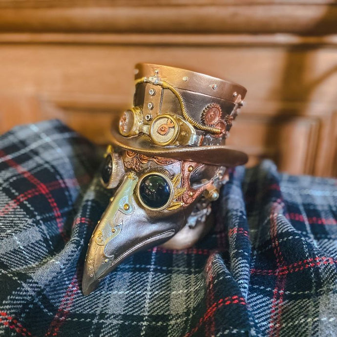 Plague doctor sculpture against the Real Mary King's Close tartan