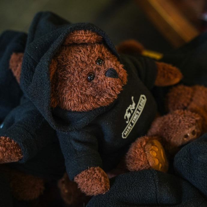 The Real Mary King's Close teddy bear wearing a branded hoodie