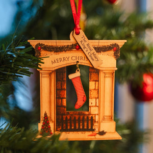 Wooden fireplace with stocking decoration hanging on a Christmas tree, labelled with a message reading "The Real Mary King's Close"