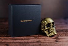Load image into Gallery viewer, Gold skull bottle opener beside an Iron &amp; Glory branded black box
