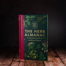 Load image into Gallery viewer, The Herb Almanac by Chelsea Physic Garden front cover displayed on a wooden slatted table
