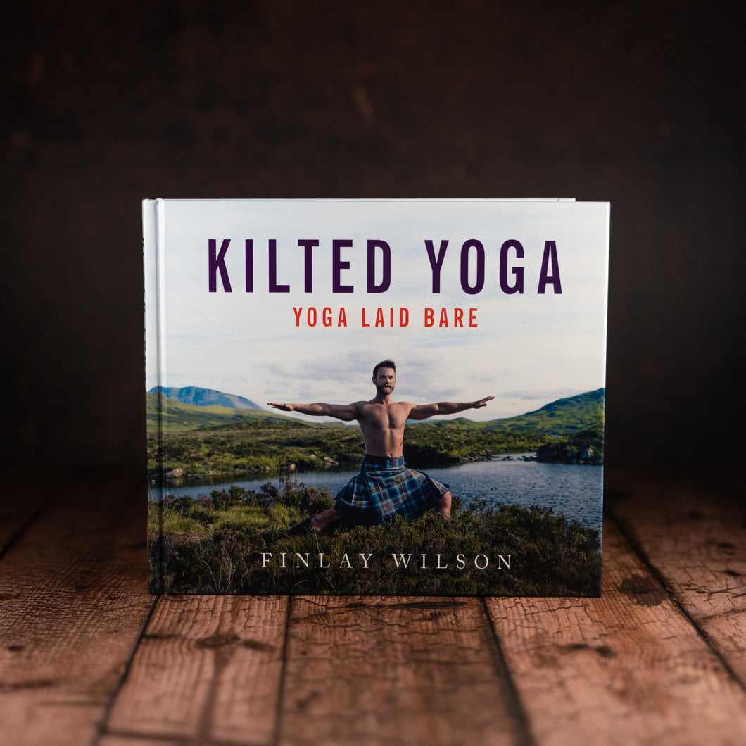 Finlay Wilson, author of 'Kilted Yoga', demonstrating yoga poses against the backdrop of Scotland's iconic scenery