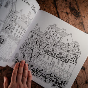 Line drawing of Edinburgh's Dean Village for colouring in as displayed in an open book
