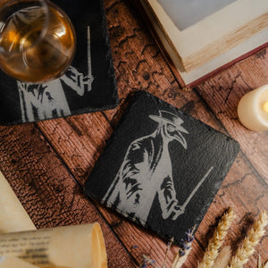 A slate coaster with a charcoal image of a full length plague doctor costume, surrounded by books and whisky