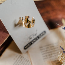 Load image into Gallery viewer, Simple golden crown ring in its The Real Mary King&#39;s Close packaging from above
