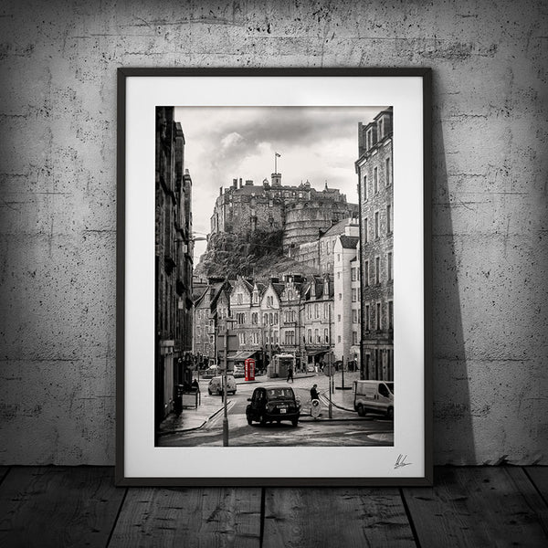Black and white line drawing of Edinburgh castle with a red post box